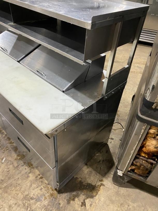 Commercial stainless steel 4-drawer refrigerated prep table with Bain Marie style; includes overhead shelf and cutting board.