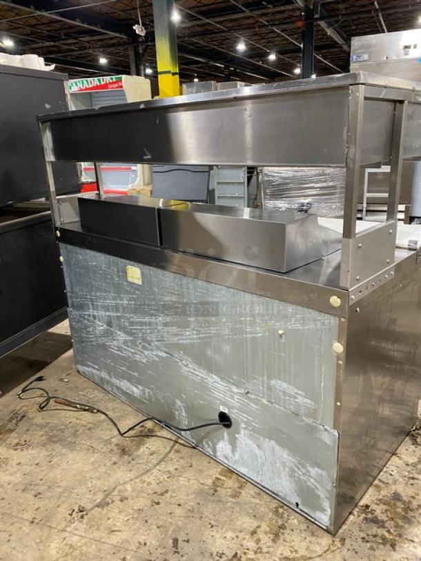Commercial stainless steel prep table with 4 refrigerated drawers, enclosed double compartment shelf, and cutting board.