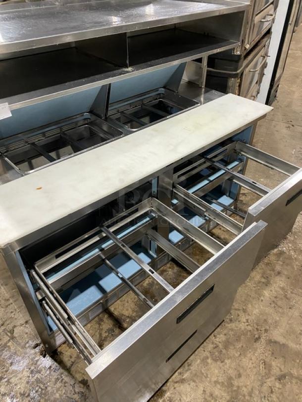 Commercial stainless steel 4-drawer refrigerated Bain Marie prep table with double compartment overhead shelf and cutting board.