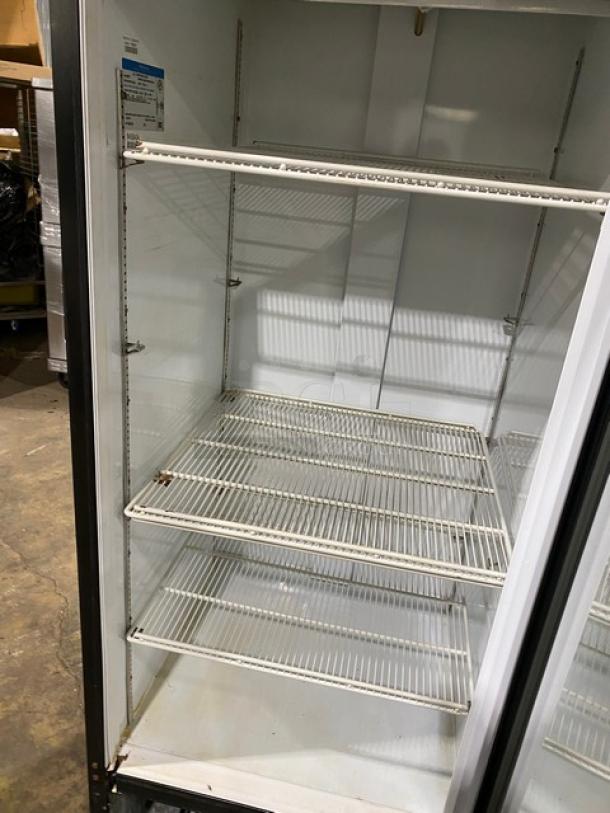 Beverage-Air MT27 reach-in merchandiser refrigerator with a black single glass swing door and poly-coated wire racks. Model SN: 6458494, 115V, 1 Phase. Good condition.