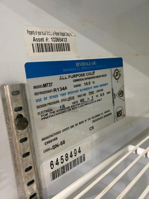 Beverage-Air MT27 commercial reach-in merchandiser fridge with glass door, poly-coated wire rack, model label, SN: 6458494.