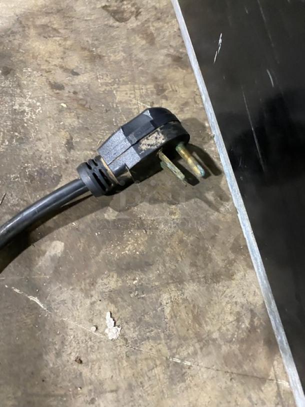 Close-up view of a power plug for the MerryChef Eikon E3 rapid cook oven, highlighting its 208/240V capability.