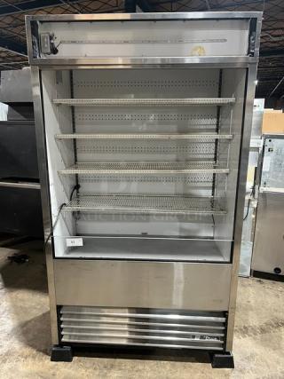 True TAC-48-LD refrigerated display case, stainless steel, multi-tier, with adjustable wired racks, on legs, 208-230V.