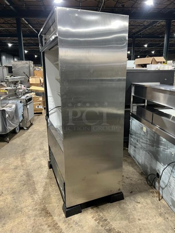 True TAC48LD refrigerated display case, stainless steel, multi-tier, poly coated racks, 208-230V, 1 Phase, on legs.