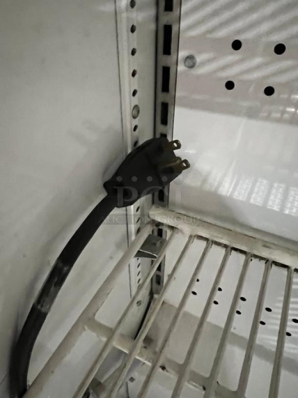 True TAC48LD stainless steel refrigerated display case, multi-tier, adjustable wired rack, 208-230V, on legs.