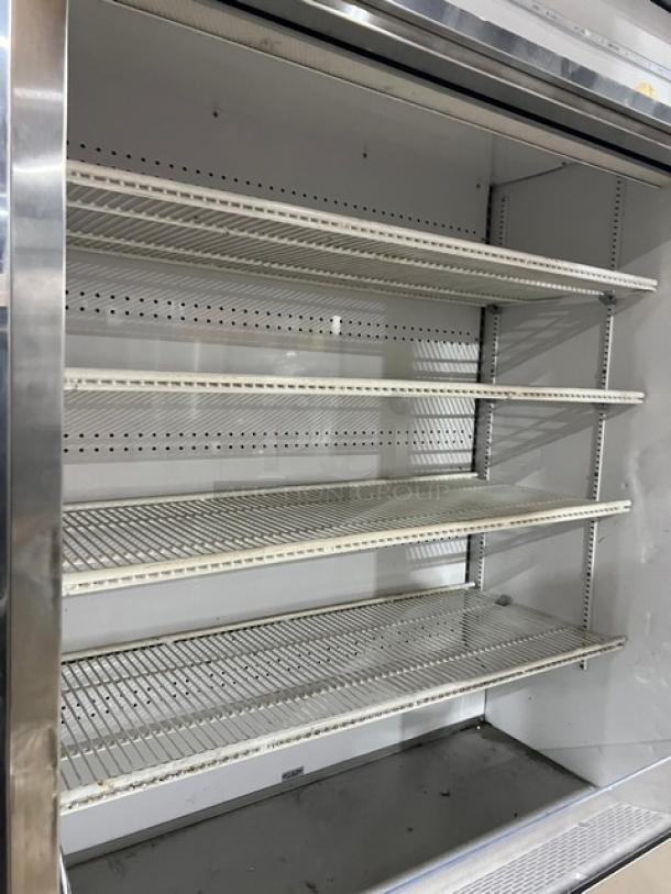 True TAC48LD stainless steel refrigerated display case, multi-tier with adjustable poly-coated racks, 208-230V, on legs.