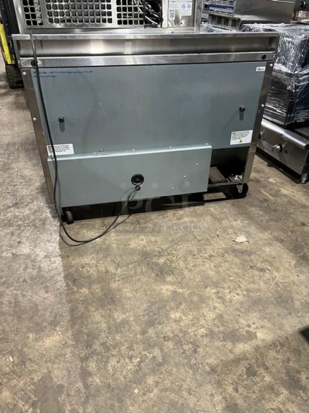 True TWT48HC commercial stainless steel 2-door undercounter refrigerator, Energy Star certified, with upturned back splash, on casters.