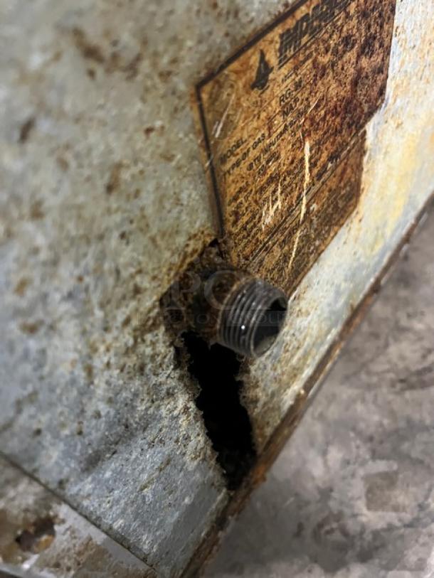 Imperial RG36 commercial stainless steel gas griddle, rusted surface with visible label, fitted leg, upturned backsplash.