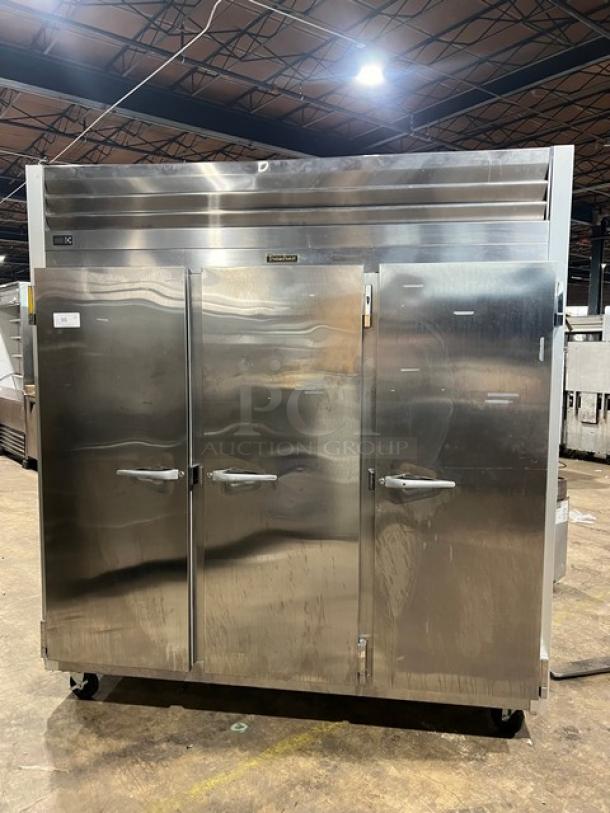 Traulsen G-Series stainless steel triple door reach-in freezer, model G31010, on casters, with poly coated racks.