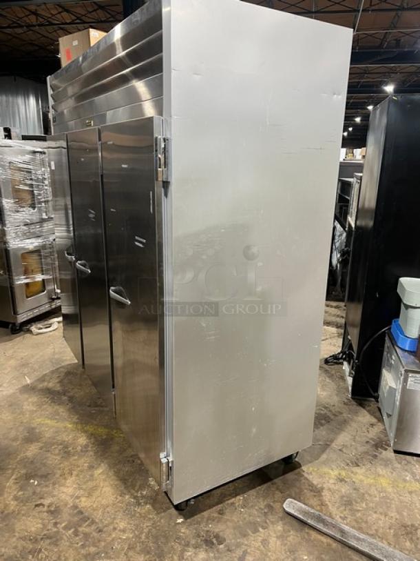 Traulsen G-Series stainless steel triple-door reach-in freezer, model G31010, with poly-coated wire rack, on casters.