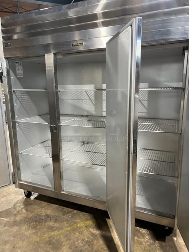 Traulsen G-Series triple swing door reach-in freezer, Model G31010, stainless steel, poly-coated racks, on casters.