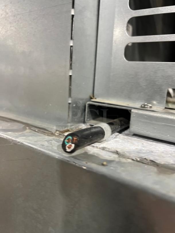 Close-up of part of the Traulsen G-Series freezer model G31010. Details of the power cable and metal casing visible.