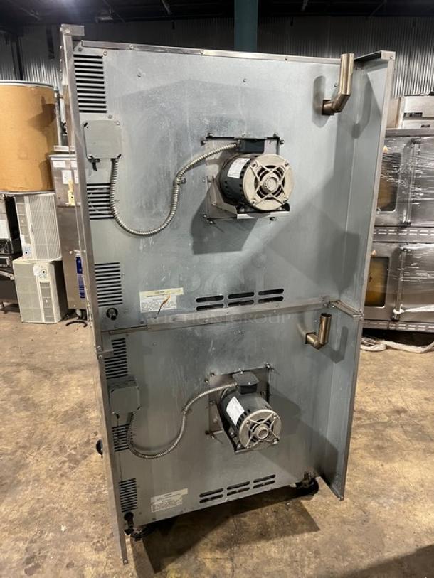 Imperial double-stacked convection oven, natural gas, stainless steel, wired rack, on casters, commercial use, rear view.