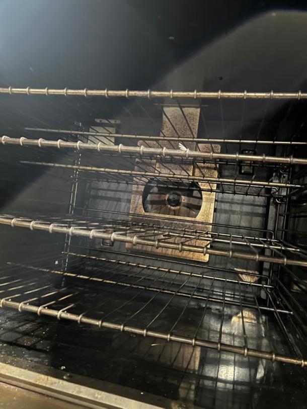 Imperial stainless steel double-stacked convection oven with wired rack, natural gas powered, on casters. Interior view.