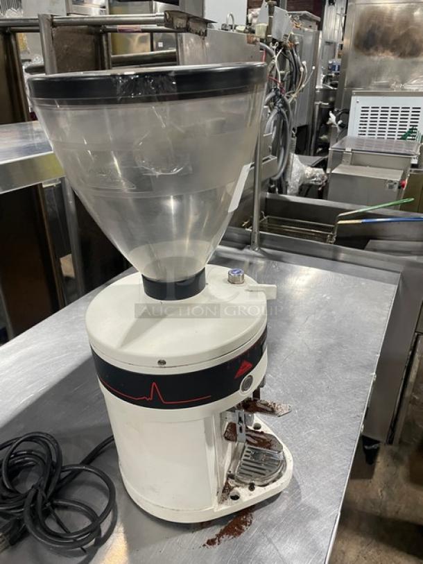 White Mahlkonig PEAK Series espresso grinder with clear hopper, electric-powered, on stainless steel countertop. Late model, 2019.