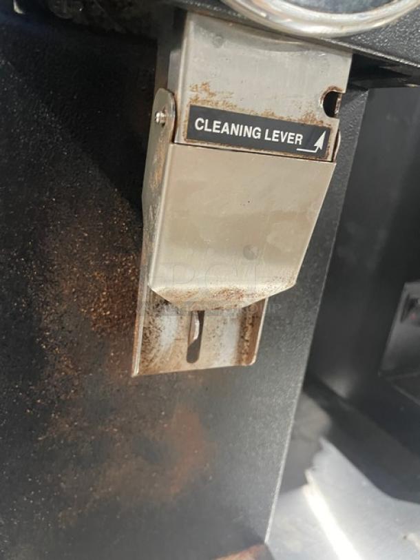 Bunn G1HD coffee grinder, commercial black, features a cleaning lever, electric, countertop model, slight rust present.