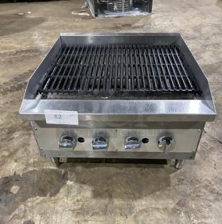 Commercial stainless steel gas countertop char broiler, wavy grates, on legs, four control knobs, used condition, tag labeled "82 QTY."