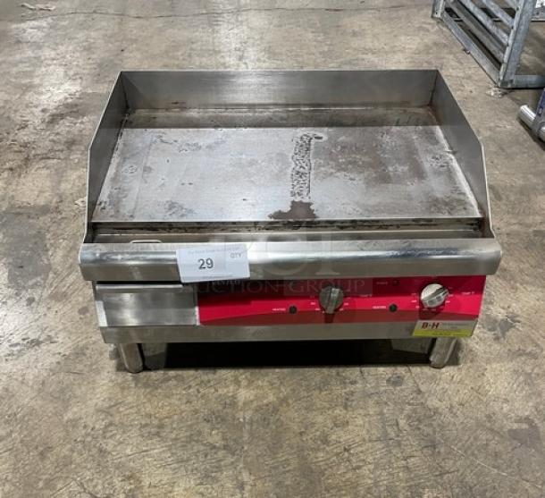 Avantco 24" stainless steel electric countertop griddle, model 177EG24N, with back and side splash, on legs, 208/240V.