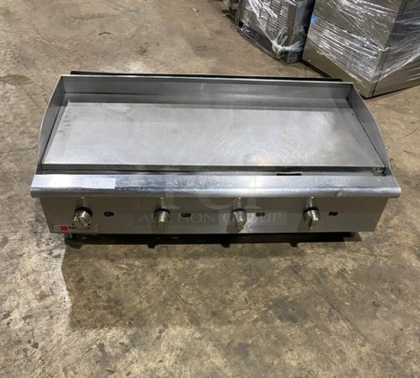 Cecilware Pro stainless steel natural gas countertop flat griddle with back and side splash, on legs. Four control knobs.