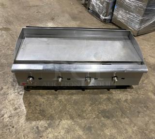 Cecilware Pro stainless steel natural gas countertop flat griddle with back and side splash, on legs. Four control knobs.