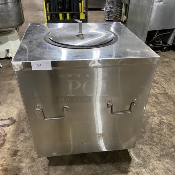 Commercial stainless steel natural gas powered tandoor oven on casters. Features durable handles. Good condition.