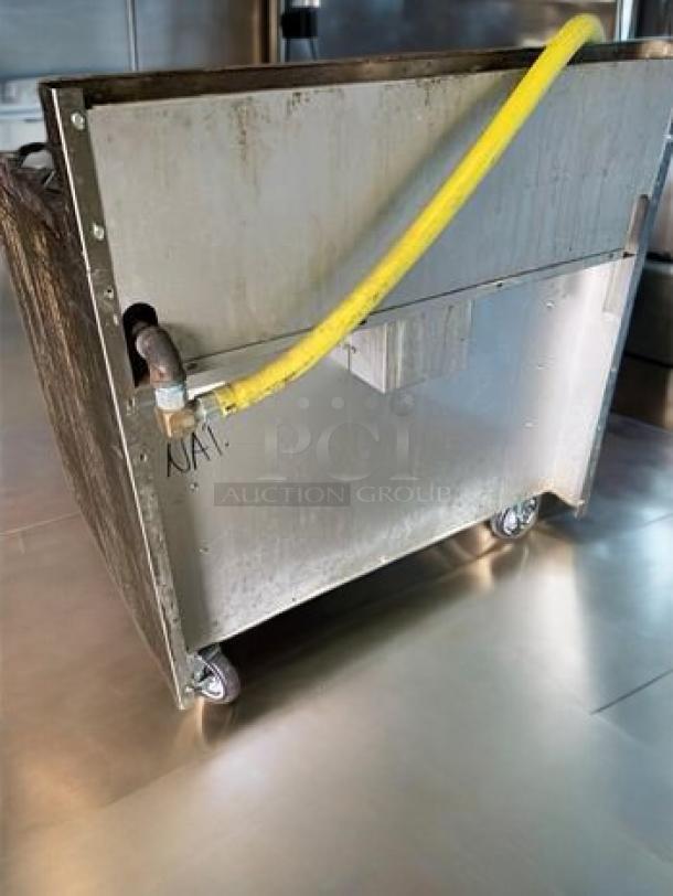 Royal Range of California RR-6-C gas range back view, stainless steel, yellow gas line, on casters.