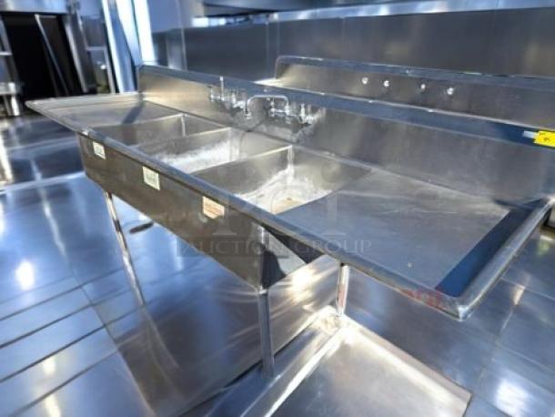 Stainless steel 3-compartment sink with dual drainboards and faucet. Model 3CS-182414-2D, NSF certified, superb condition.