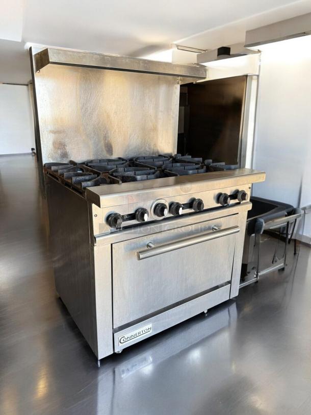 Connerton CR-6 gas range with six burners and oven, natural gas, outstanding condition, fully tested, stainless steel finish.