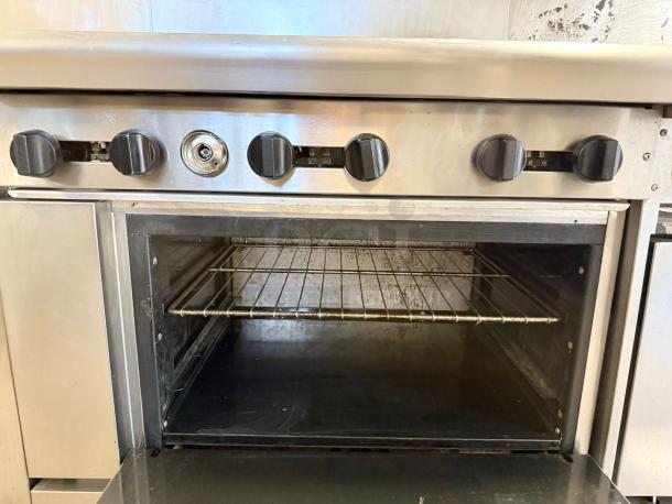 American Range AR-10 gas range with ten burners and double oven, shown in superb condition with functional knobs.