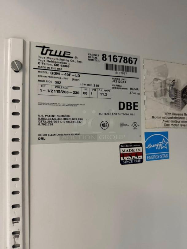 Close-up of True GDM-49F-LD freezer merchandiser label, showing model, voltage, and Energy Star rating. Made in USA.