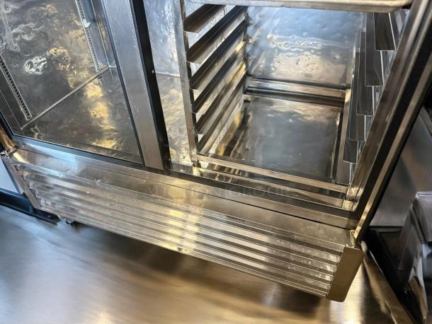 Alt text: True T-49-HC double door reach-in refrigerator interior; stainless steel, superb condition, fully tested, model details visible.