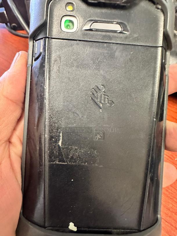 Zebra TC51/TC56 device back, showing camera and logo, condition suggests signs of use. Cradle not visible.