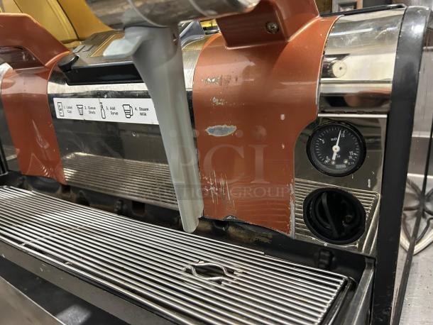 Thermoplan Mastrena II espresso machine, commercial model, worn exterior, labeled with brewing instructions, gauge visible.