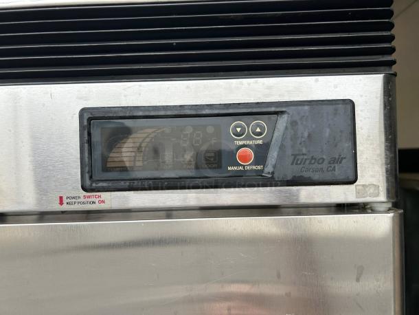 Turbo Air TSF-49SD-N freezer panel with digital display, temperature controls, and manual defrost button. Power switch labeled.