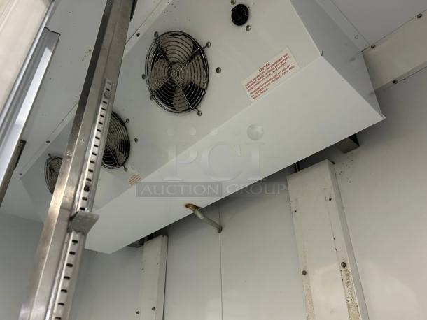 Beverage-Air CRG74-1 merchandiser interior; features cooling fans and shelving supports. Labels indicate operating instructions.