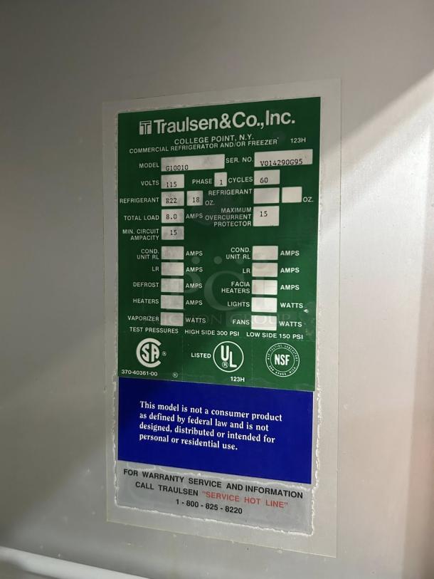 Traulsen G10010 refrigerator label indicating model, serial number, electrical specs, refrigerant details, and service info.