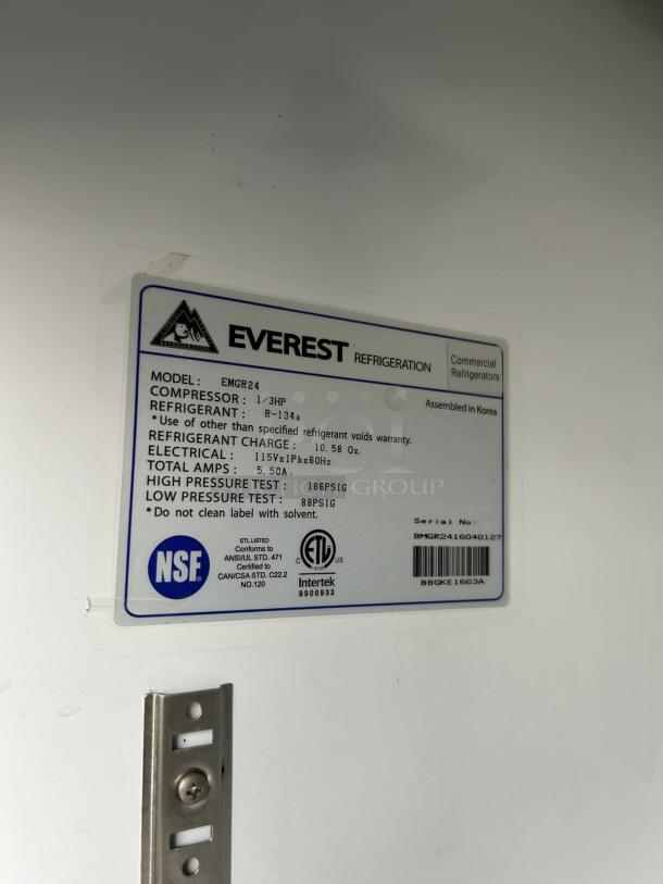 Everest Refrigeration EMGR24 label showing model, specs, and certifications. Serial number and NSF logo visible.