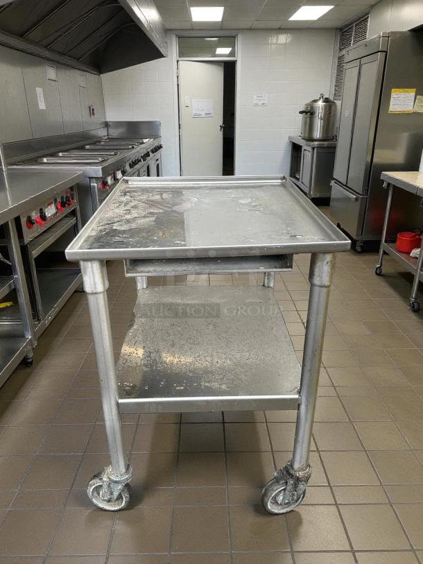 GSW stainless steel equipment stand with casters, in perfect condition. Features heavy-duty construction and easy swivel wheels.