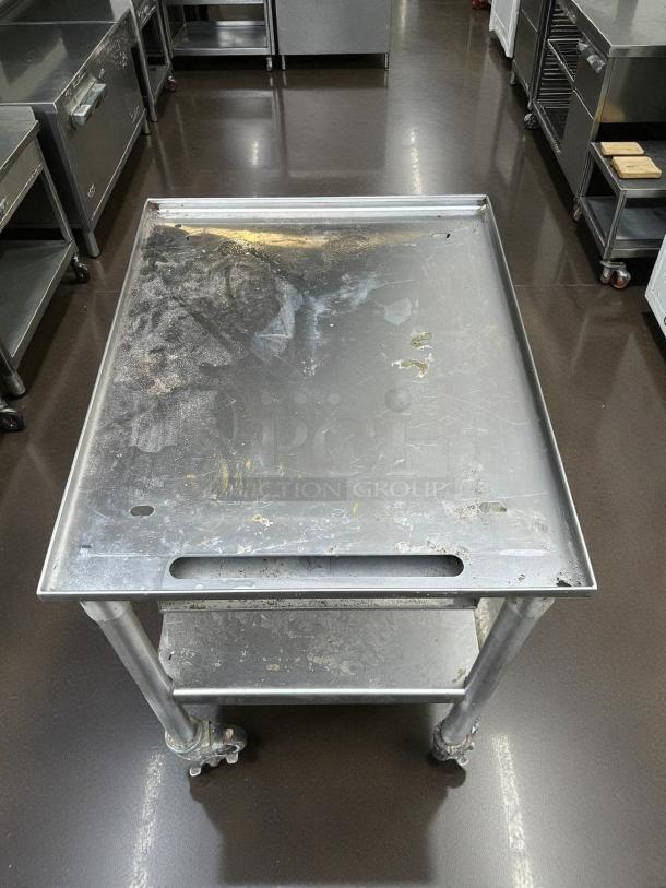 GSW stainless steel equipment stand with casters, heavy-duty, easy swivel, perfect condition, minimal surface wear.