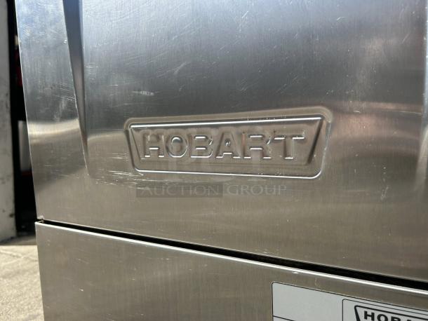 Hobart LXNH-1 undercounter dishwasher, excellent condition, with visible branding. Stainless steel exterior, tested and working.