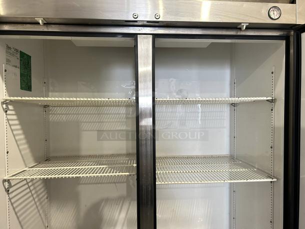 True T-49-HC 54 1/8" solid door reach-in refrigerator in excellent condition, interior view with shelving, label visible.