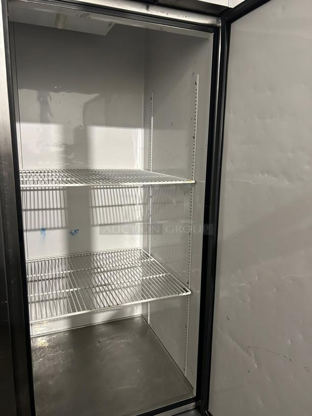 True T-49-HC reach-in refrigerator with solid door, 54 1/8", tested working condition, interior shelving visible.