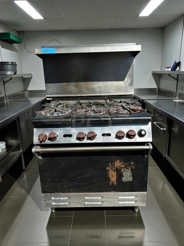 Wolf Commercial WX36-6B gas range with 6 burners, excellent condition, tested and working, some surface wear visible.