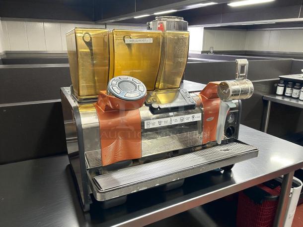 Thermoplan Mastrena II espresso machine in working condition; features dual hoppers, control panel, and attached milk frother.