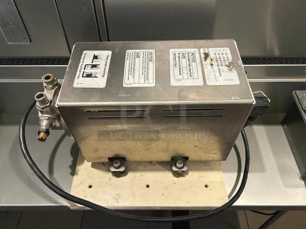 Thermoplan Mastrena II 2 Espresso Machine pump unit. Stainless steel, tested working. Tags show electrical specs: 209-240v, 1ph.