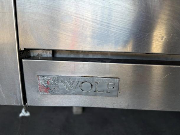 Wolf WX36-6BP 36" 6 Burner Gas Range in excellent condition, featuring a standard oven and visible branding.