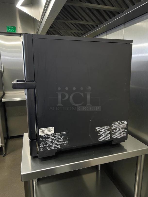 Merrychef eikon e1s high-speed cooking oven in excellent condition, black finish, visible safety and warranty labels.