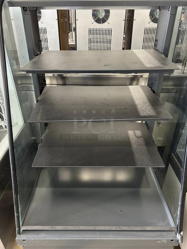 Structural Concepts dry pastry/bread display case with four shelves, glass sides, and chrome frame. Tested and working.