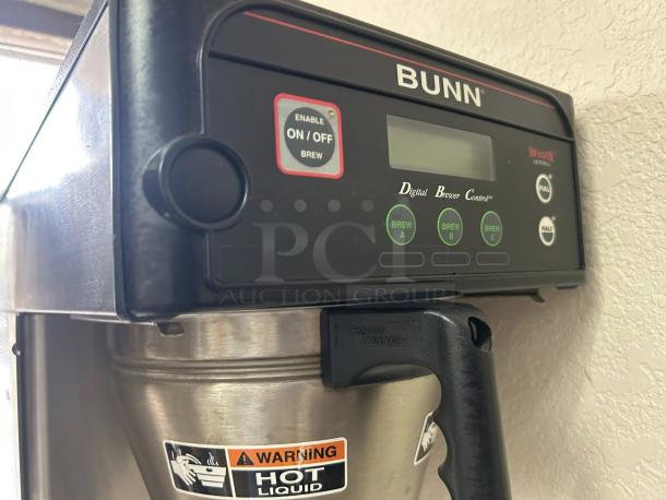 Bunn 53100.0001 BrewWISE ICB-DV coffee brewer, stainless steel, dual voltage, digital control, warning labels visible.