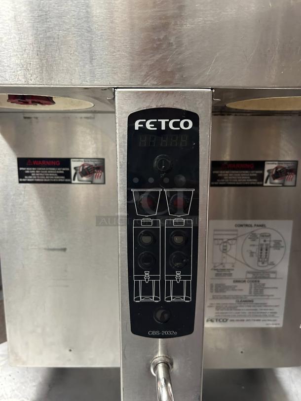 Fetco CBS-2032e coffee brewer in excellent condition, stainless steel, tested and working, visible control panel and warnings.